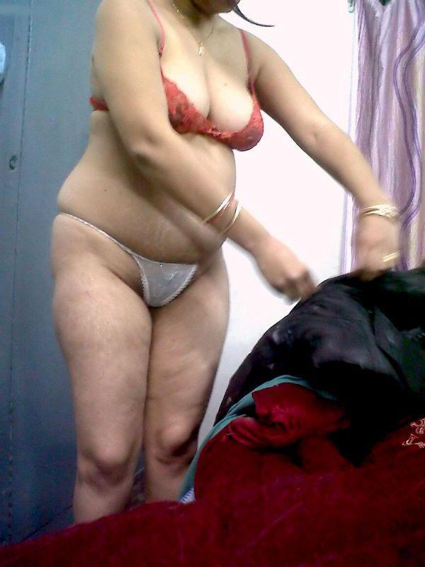 Fat Indian woman hides her face while adorned in a bra and thong(9)