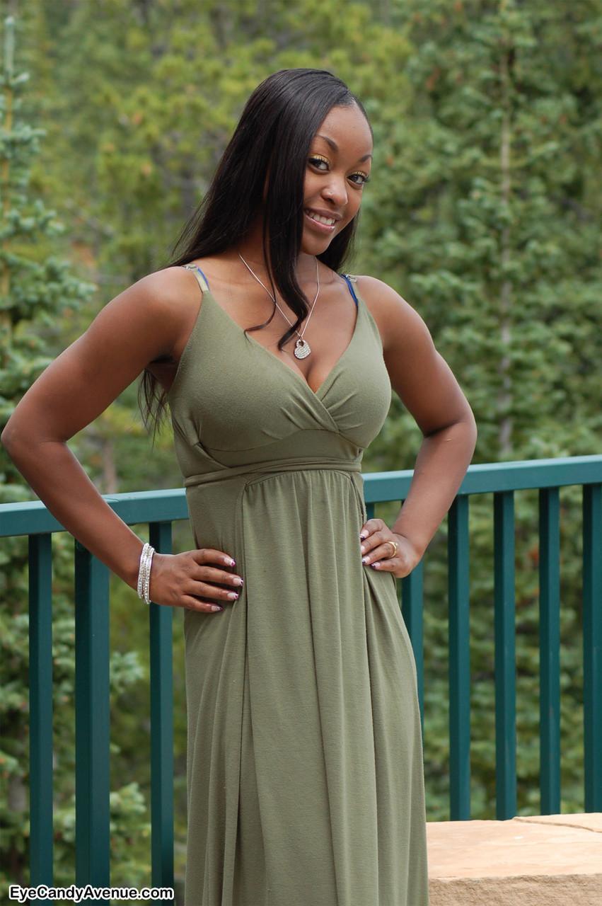 Ebony amateur Amber releases her big tits from a long dress on a balcony(2)