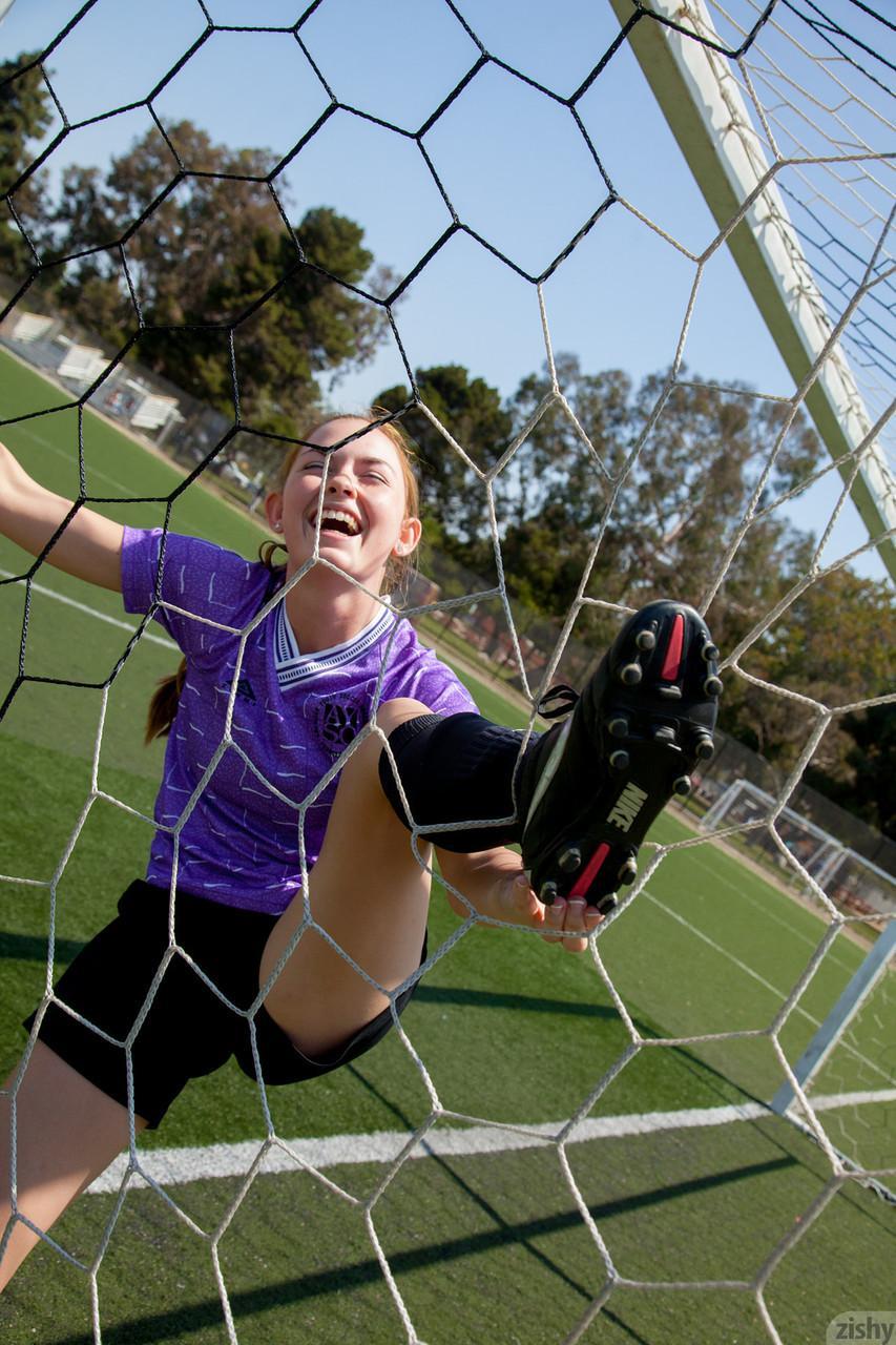 Sporty redhead teen Bailey Rayne flashes her tight ass on the soccer field(6)