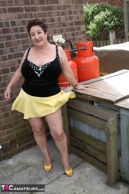 Fat older woman Kinky Carol flashes her bra and upskirt underwear on a patio(8)