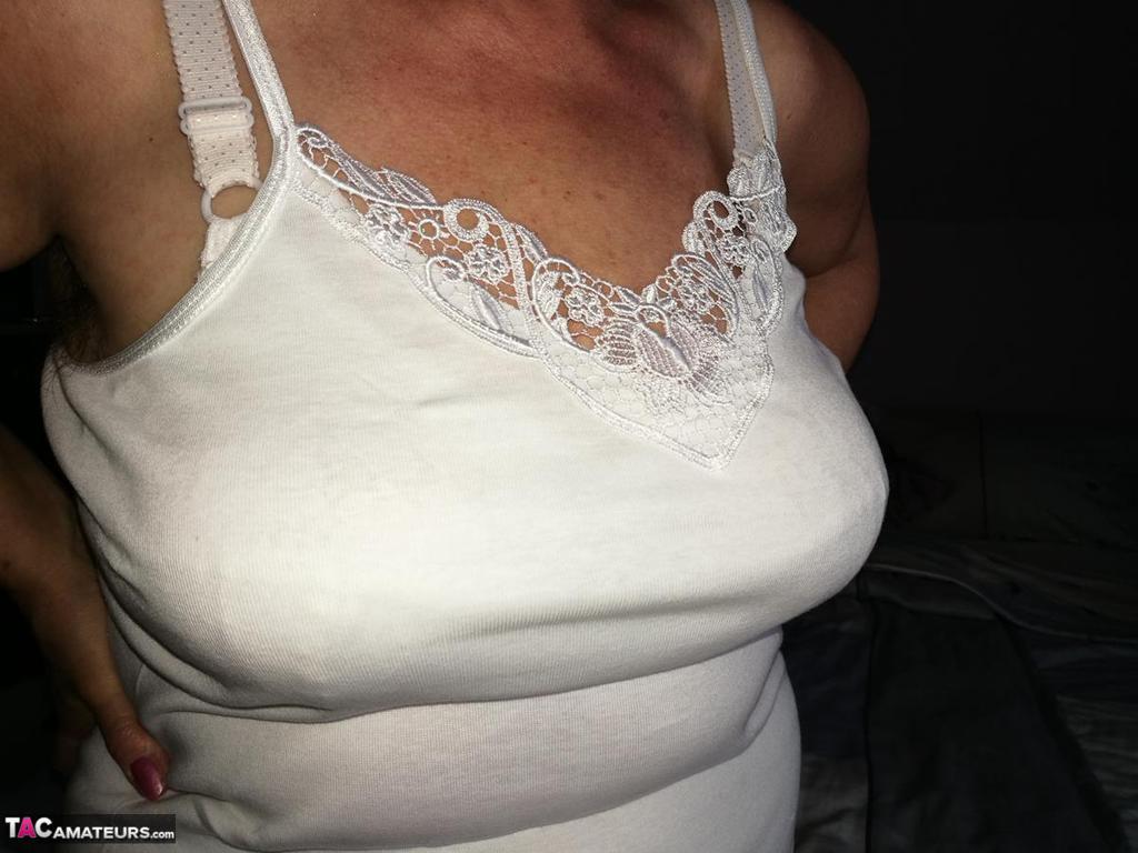 Naughty granny exposes her boobs while changing attire in nylons and heels(11)