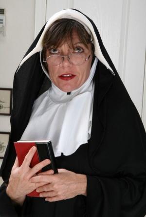 Mature nun Lacy gets rid of her habit and spreads her super hairy pussy