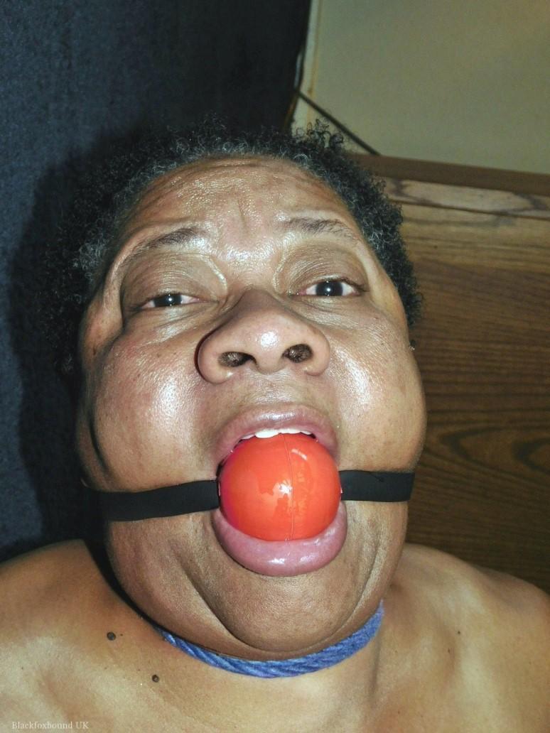 Overweight black woman Trixie struggles against a ball gag while hogtied(6)