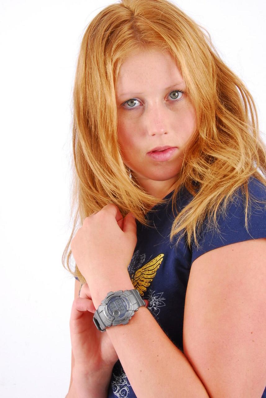 Natural redhead Judy displays her grey G-Shock watch in a T-shirt and jeans(1)