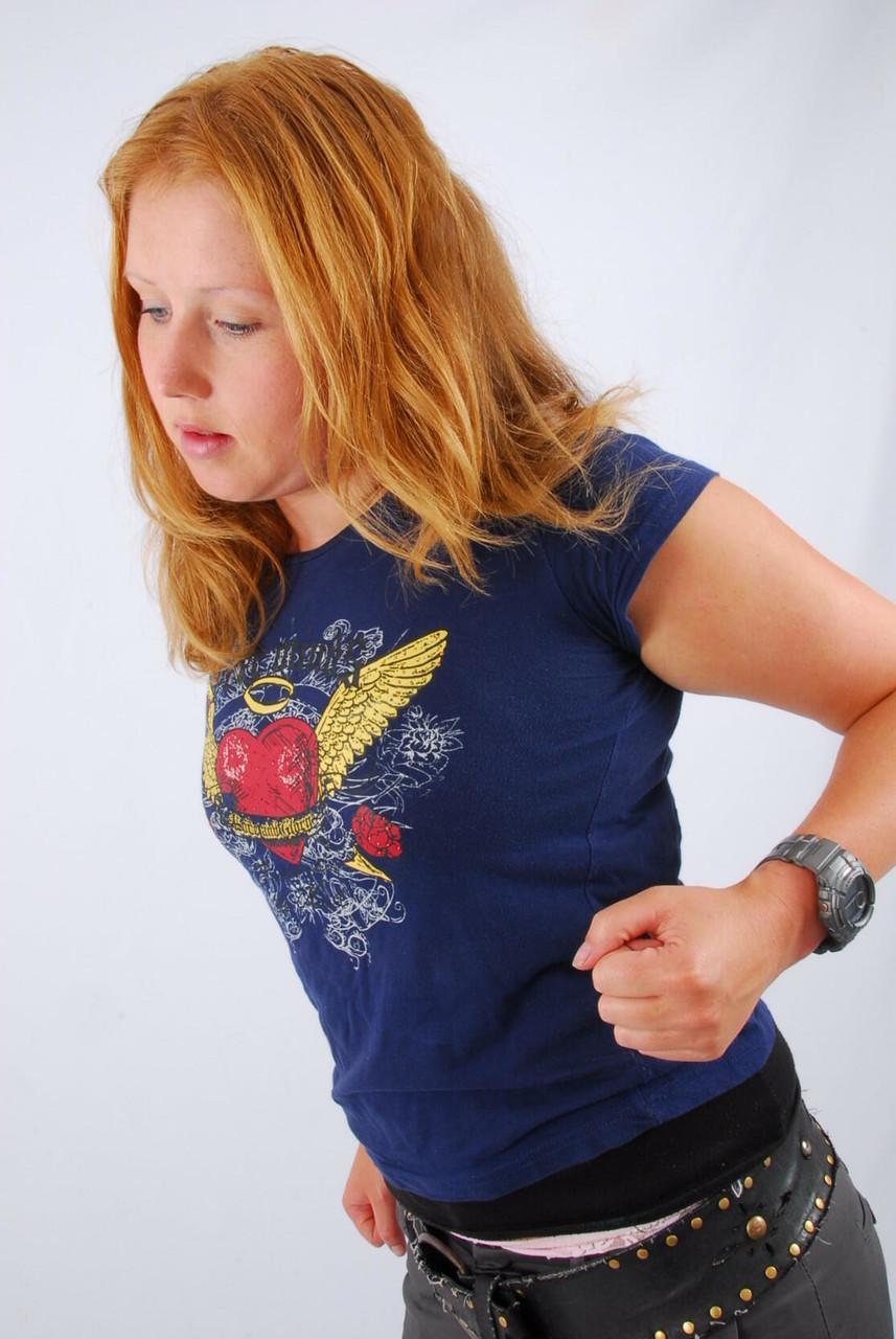 Natural redhead Judy displays her grey G-Shock watch in a T-shirt and jeans(12)