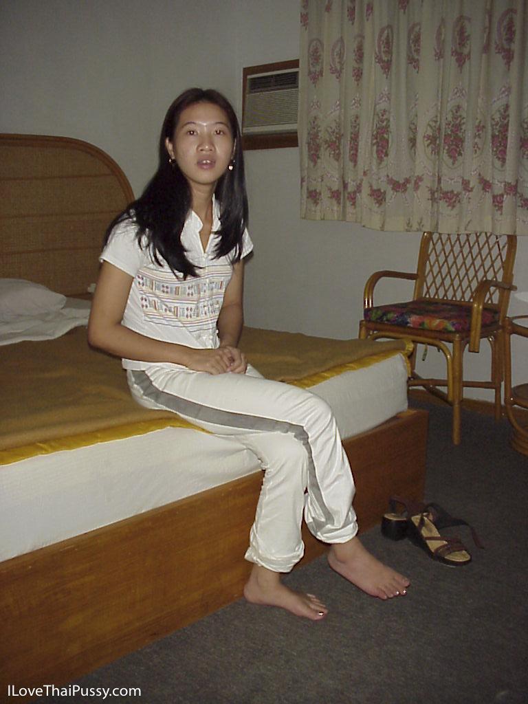 Naughty asian babe taking off her clothes and posing on the bed(1)