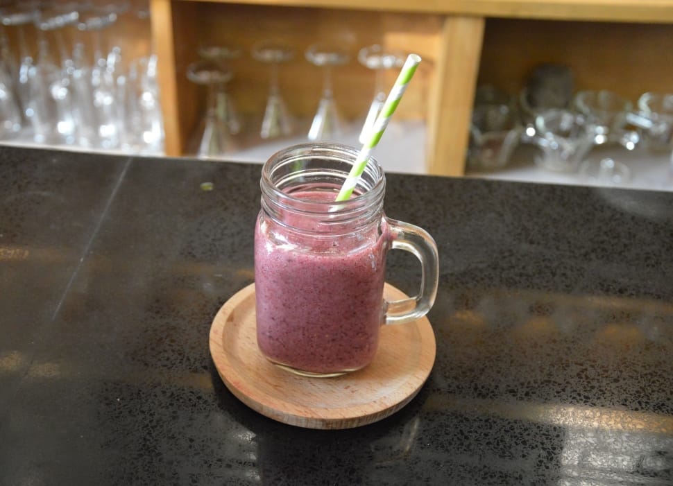 Pink smoothie in mason jar on marble counter top