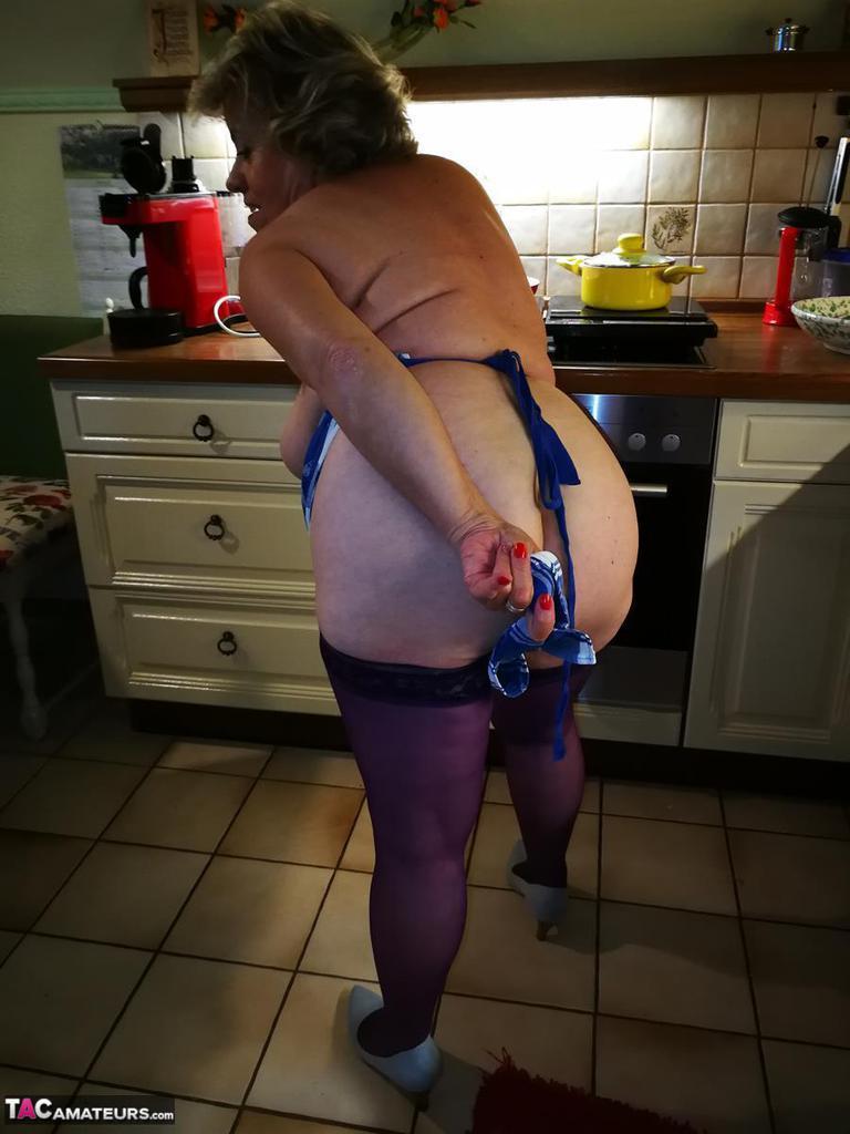 Old housewife Caro takes off her underwear in kitchen apron and stockings(15)