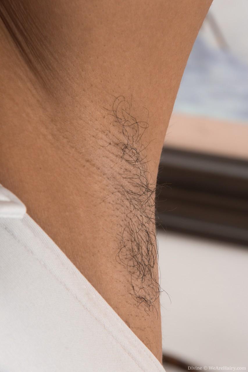 Pretty ebony Divine shows her hairy armpits & spreads her furry bush(1)