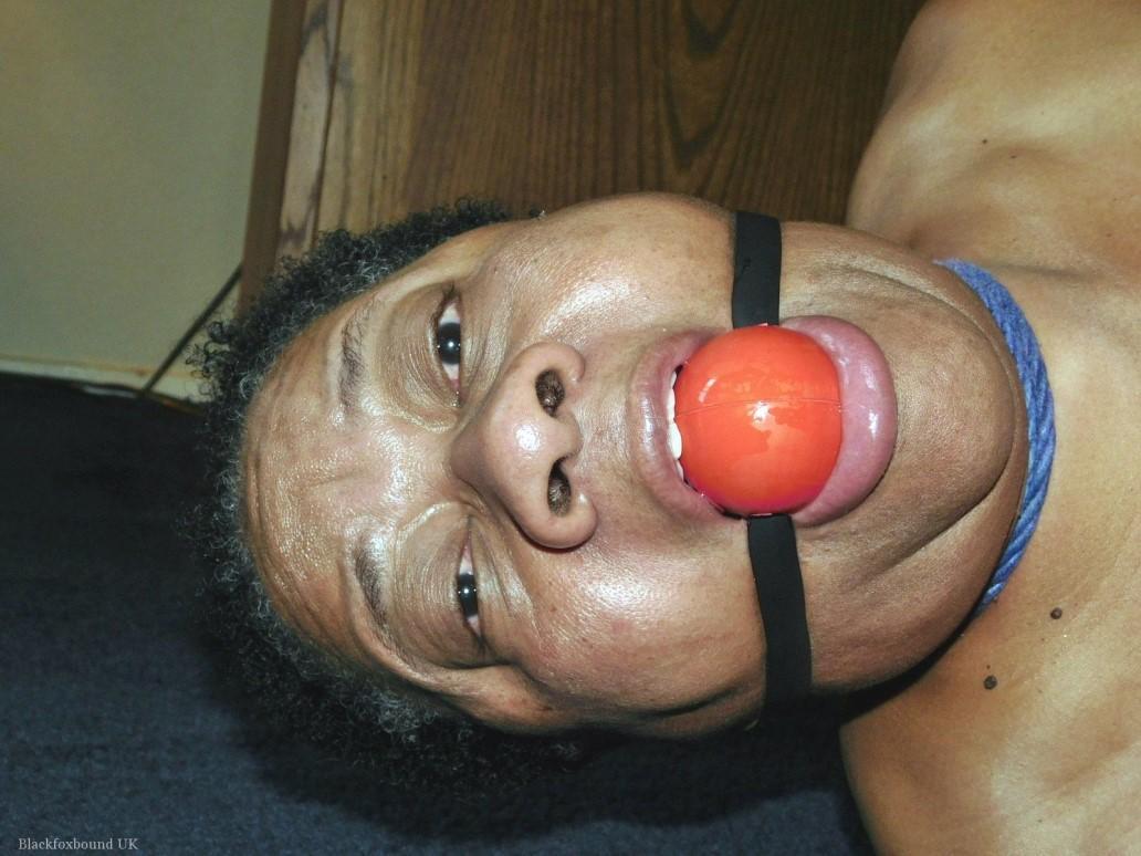 Overweight black woman Trixie struggles against a ball gag while hogtied(3)