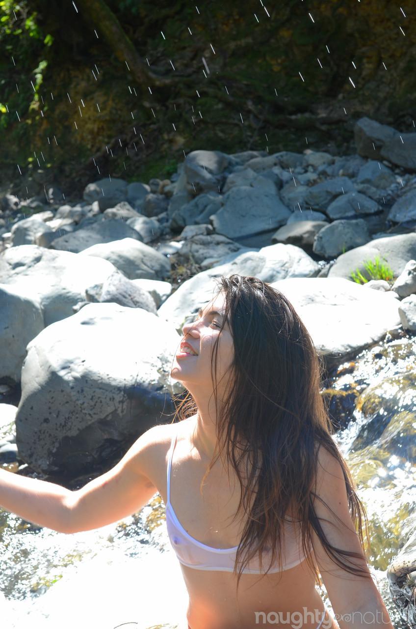 Petite teen with a small bosom Felix rubs and spreads her bush in the river(7)