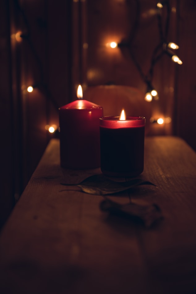 Candles and fairy lights in dark room