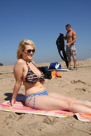 Chubby blonde sunbather Siri flaunts her big tits in a bikini on the beach