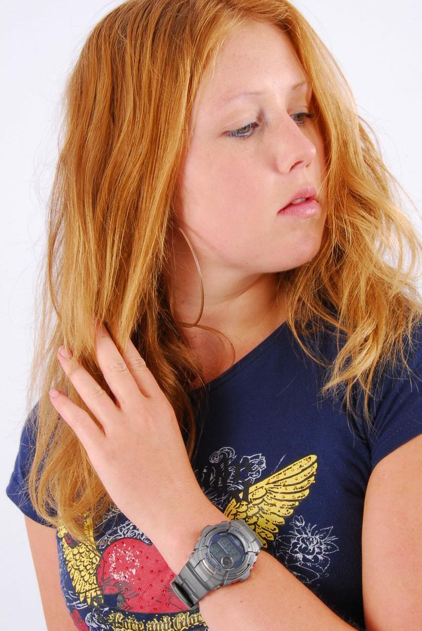 Natural redhead Judy displays her grey G-Shock watch in a T-shirt and jeans(2)