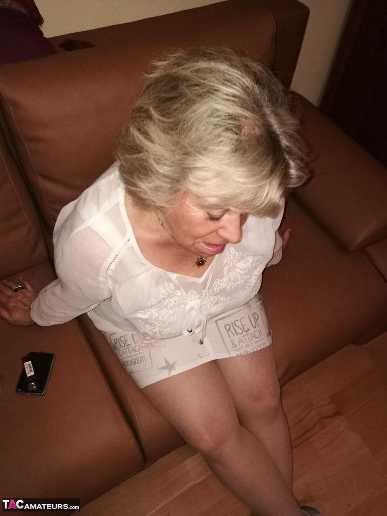 Mature lady exposes her large tits while having a smoke in pantyhose(2)