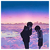 A boy and girl laughing together in front of a vast valley.