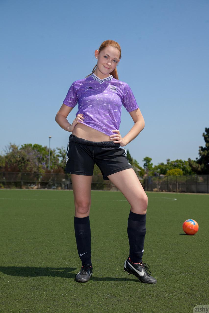 Sporty redhead teen Bailey Rayne flashes her tight ass on the soccer field(1)