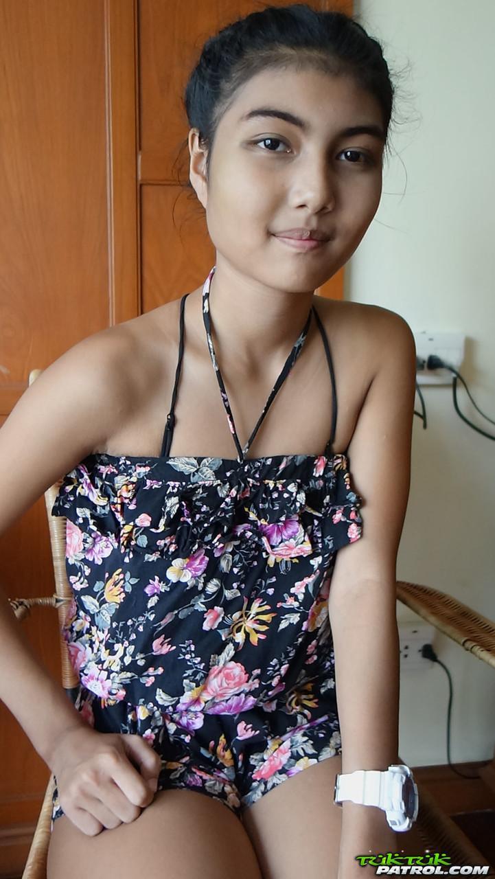 Petite Asian teen Pauw takes off her gown and flaunts her tits and hairy kitty(1)