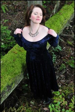 Mature woman Tasty Trixie heads into the woods to flash in a long velvet dress