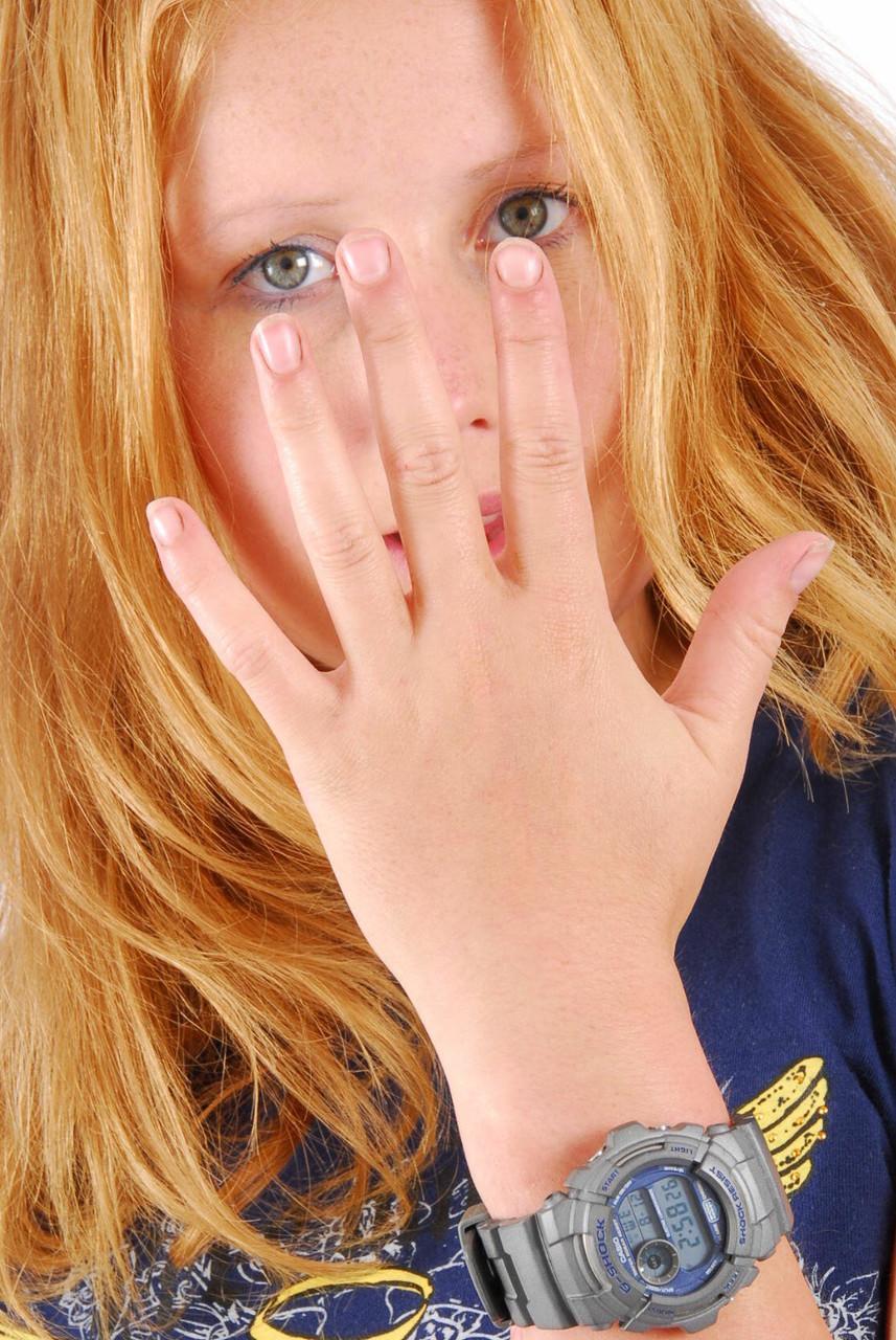 Natural redhead Judy displays her grey G-Shock watch in a T-shirt and jeans(9)