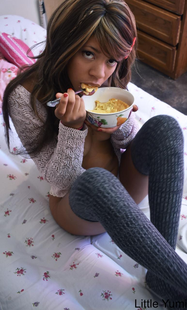 Black babe in gray socks Little Yumi flaunts her tits while eating on a bed(8)