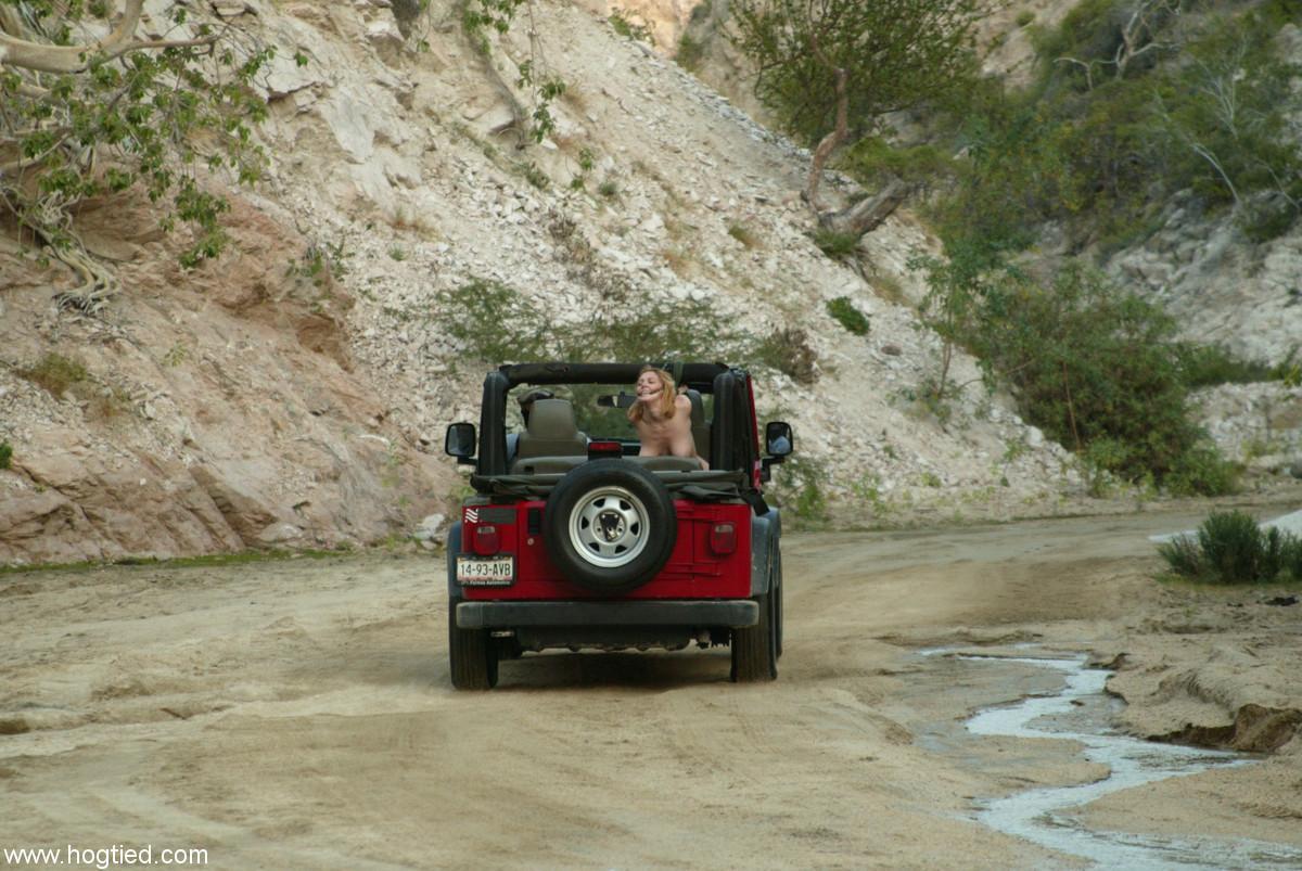 Naked MILF Dee Williams endures a rough offroad ride while standing in bondage(5)