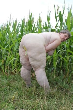 Plump European Tina C undresses in a corn field & masturbates her mature cunt