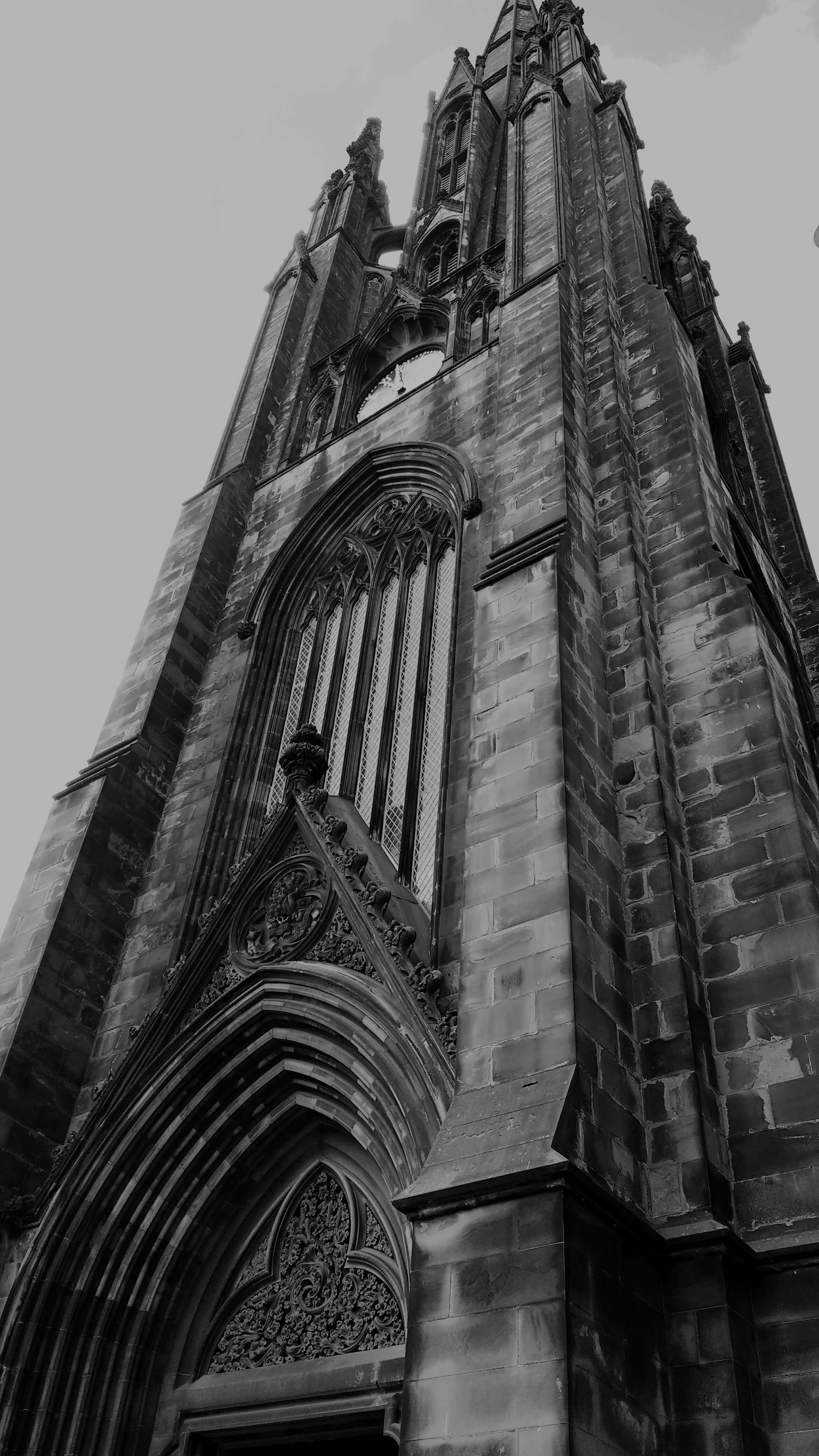 A tall gothic tower with a clock