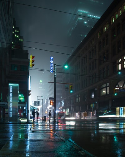Neon-lit city street on a misty night