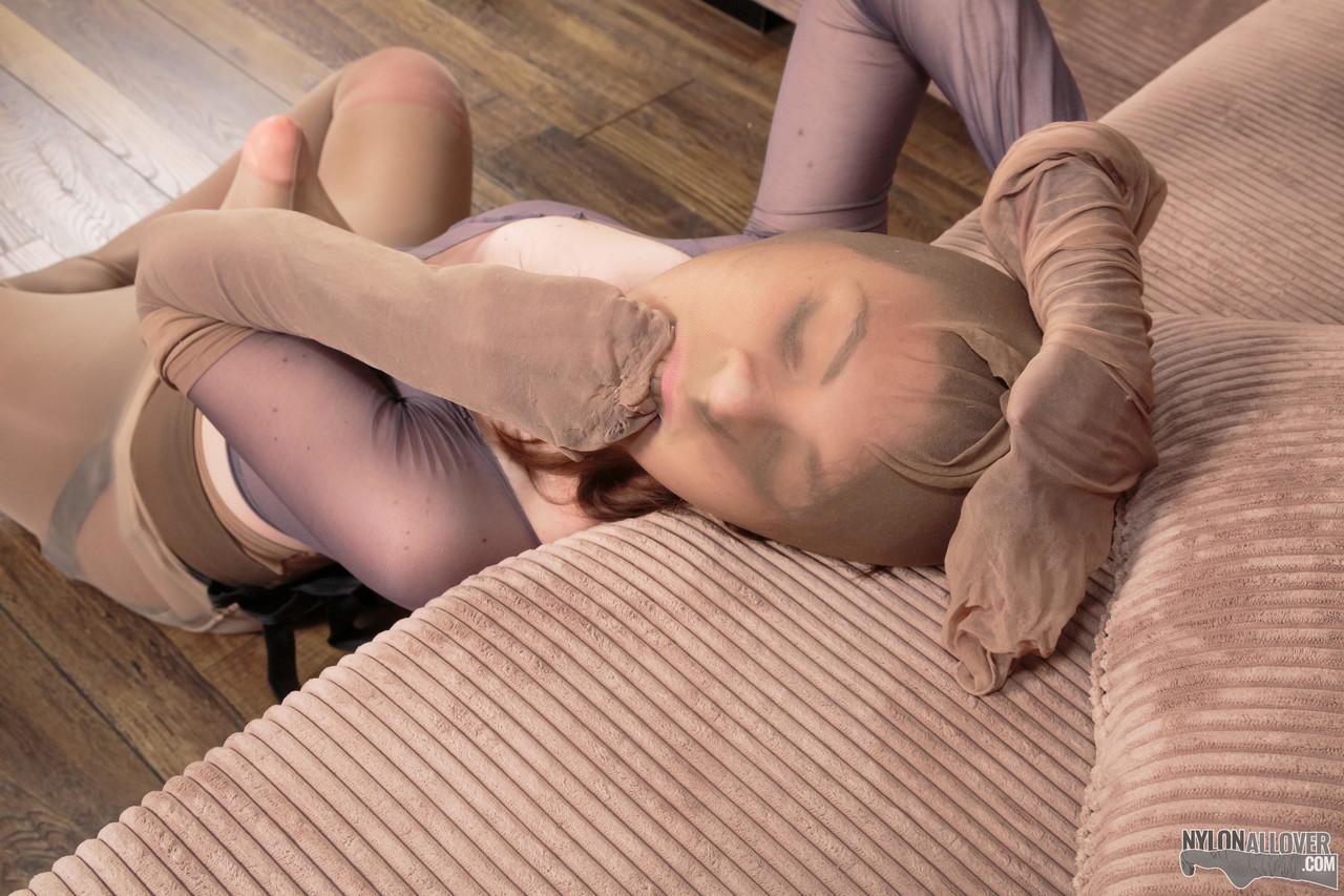 Pretty girl Mia adorns herself in layers of pantyhose and a strapon cock(14)