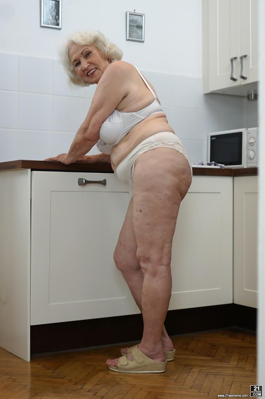 Freaky old blonde granny named Norma showing her tits in the kitchen(11)