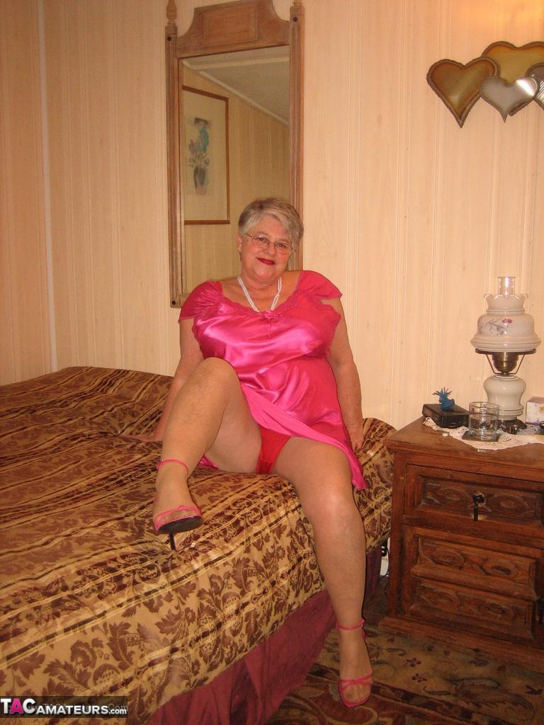 Silver haired nan Girdle Goddess pulls her hose down around her knees on a bed(5)