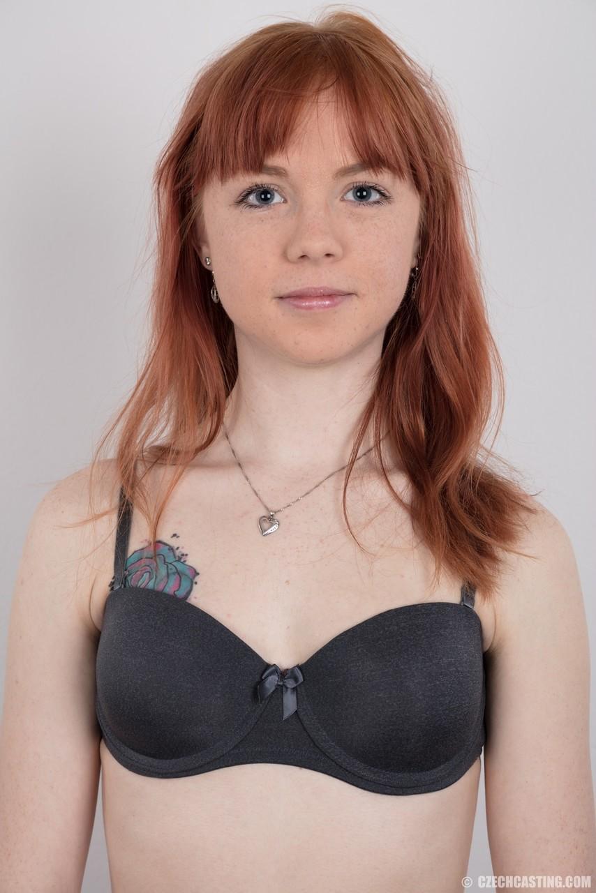 Cute redhead amateur uncovers her barely budding breasts as she gets naked(5)