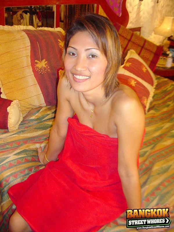 Slender Thai girl uncovers her natural tits as she removes red dress on bed(6)