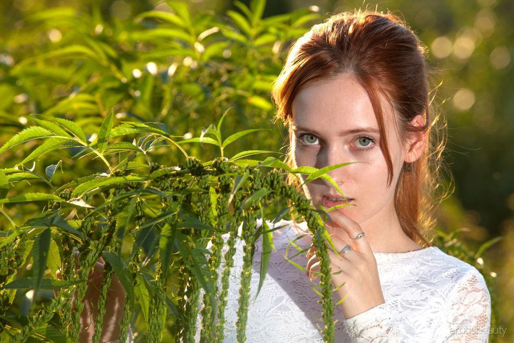 Young redhead May showcases her bald pussy on a dirt path while butt naked(1)