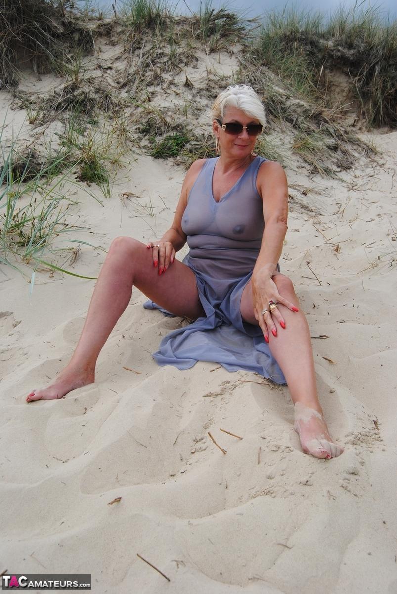 Older blonde amateur Dimonty models at the beach in see thru attire and shades(13)