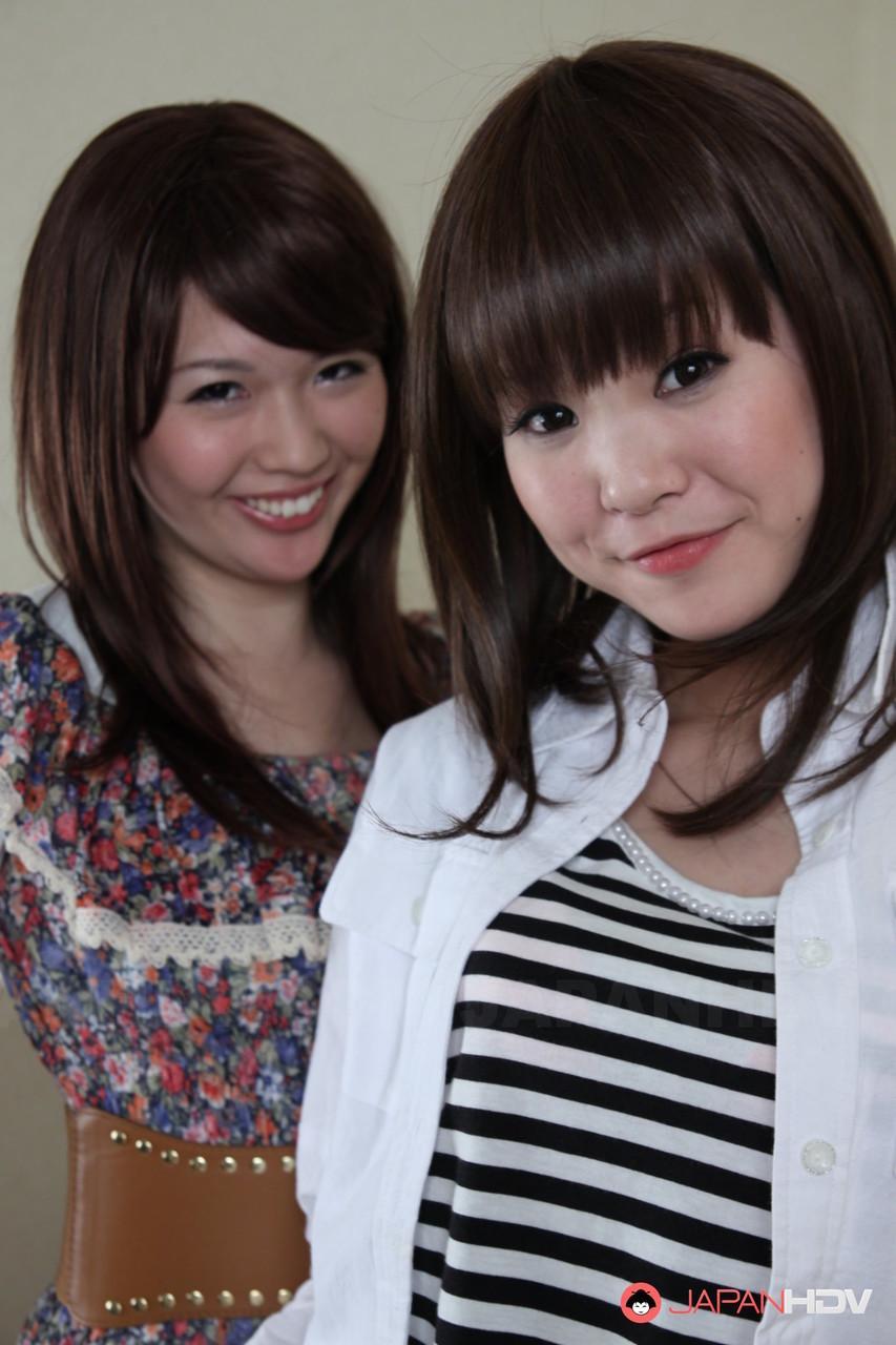 Japanese lesbians Rimu Endo & Ueno Misaki uncovers small tits as they disrobe(2)