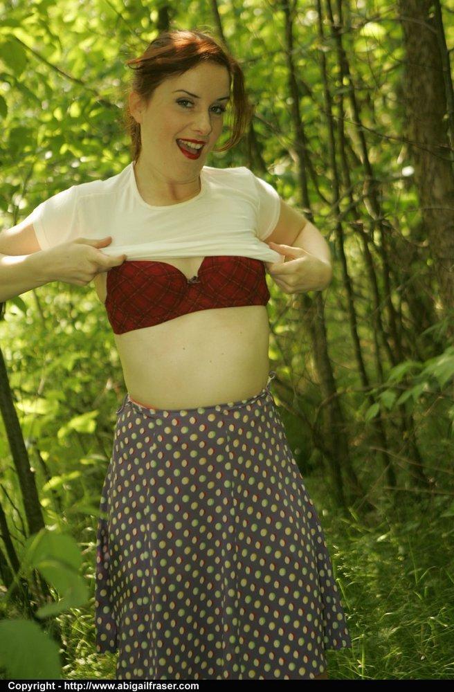 Redhead amateur pulls down satin panties in the woods before dressing(11)