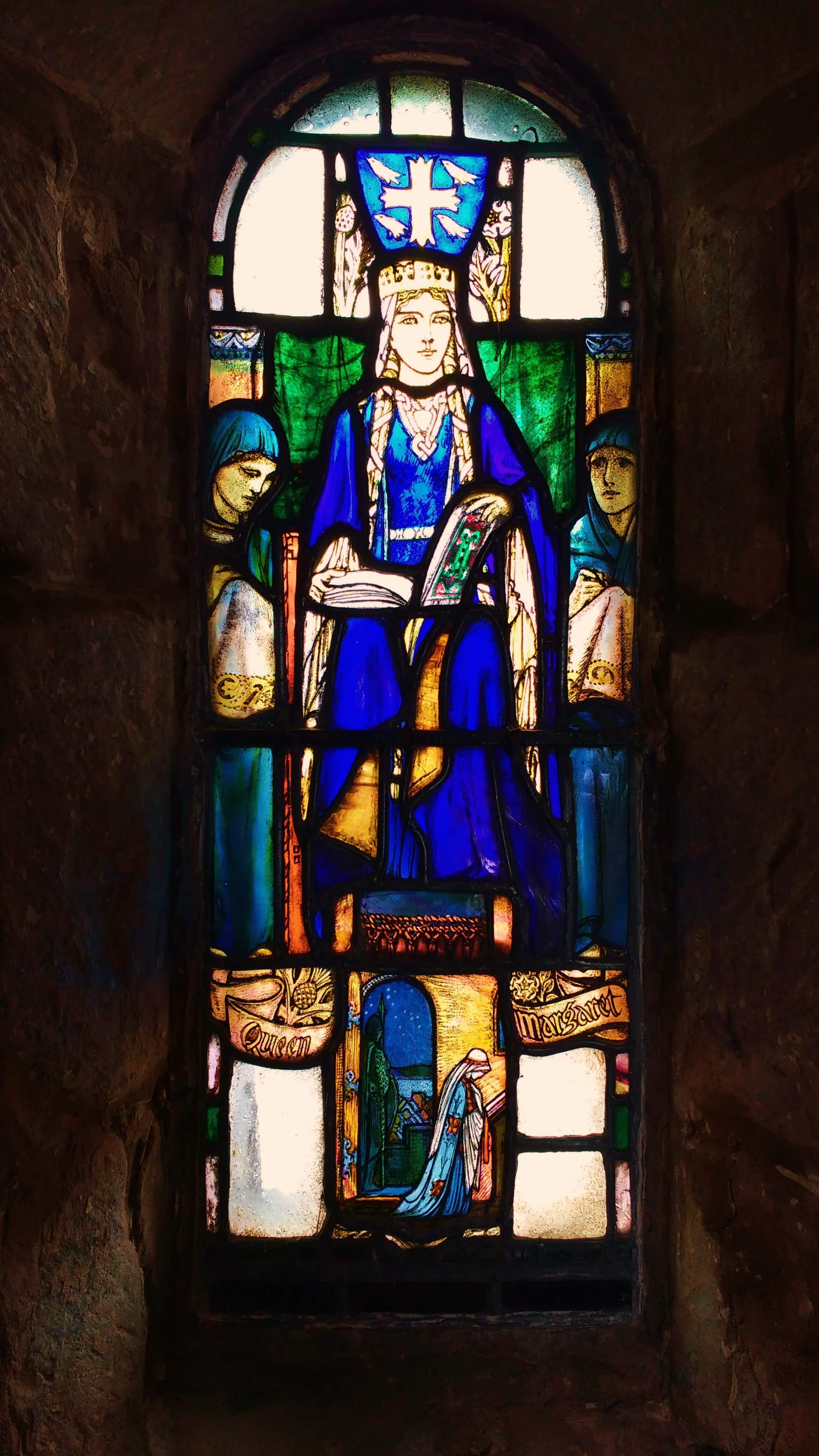 A small stained glass window of a woman named as 'Queen Margaret'