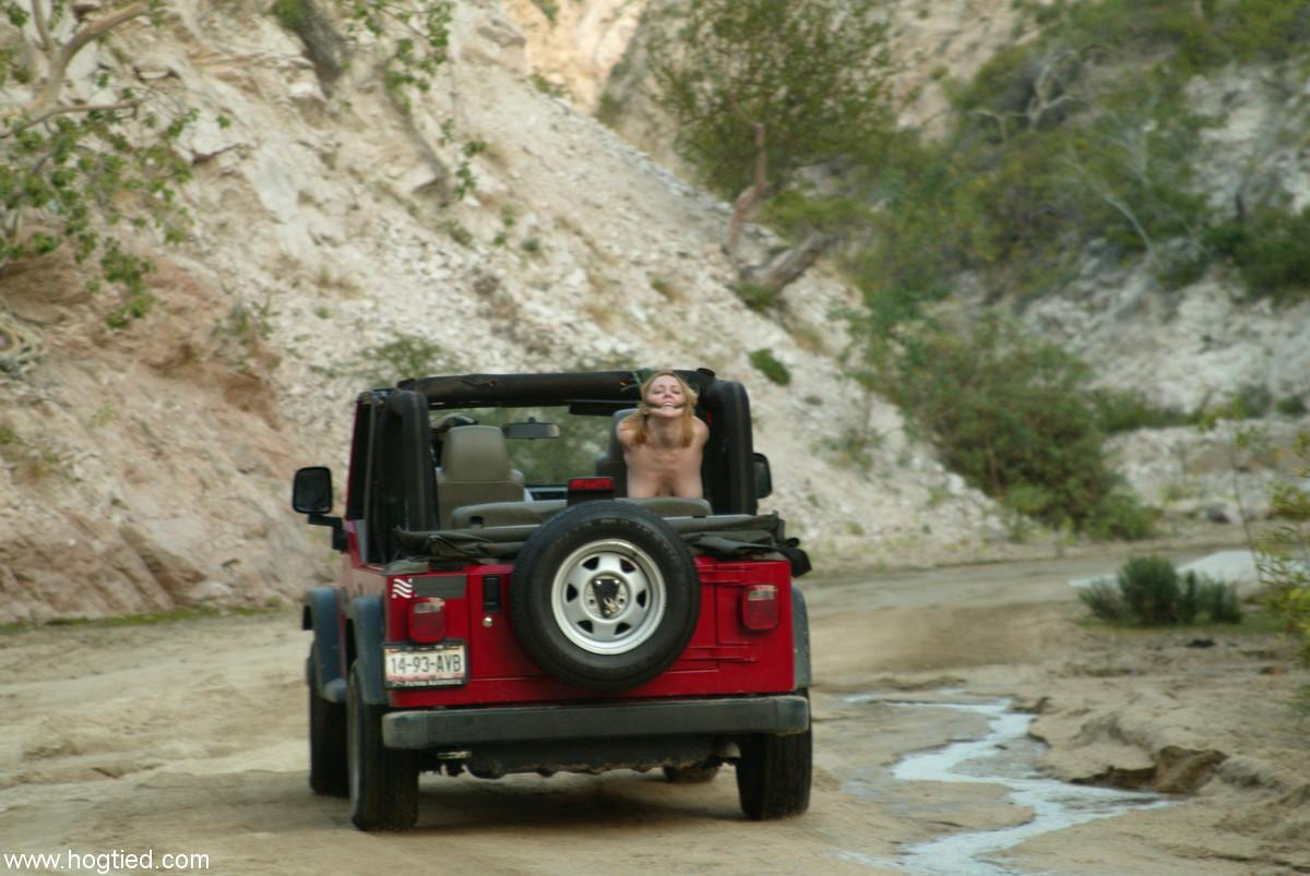 Naked MILF Dee Williams endures a rough offroad ride while standing in bondage(3)