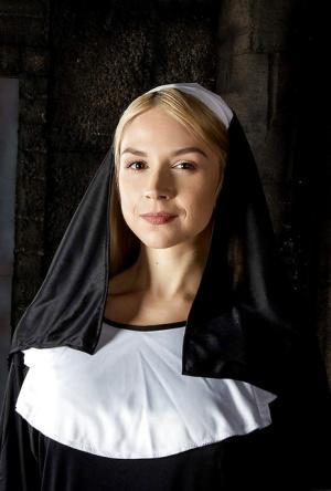 Blonde babe Sara Sloane strips off nun's uniform to expose big tits