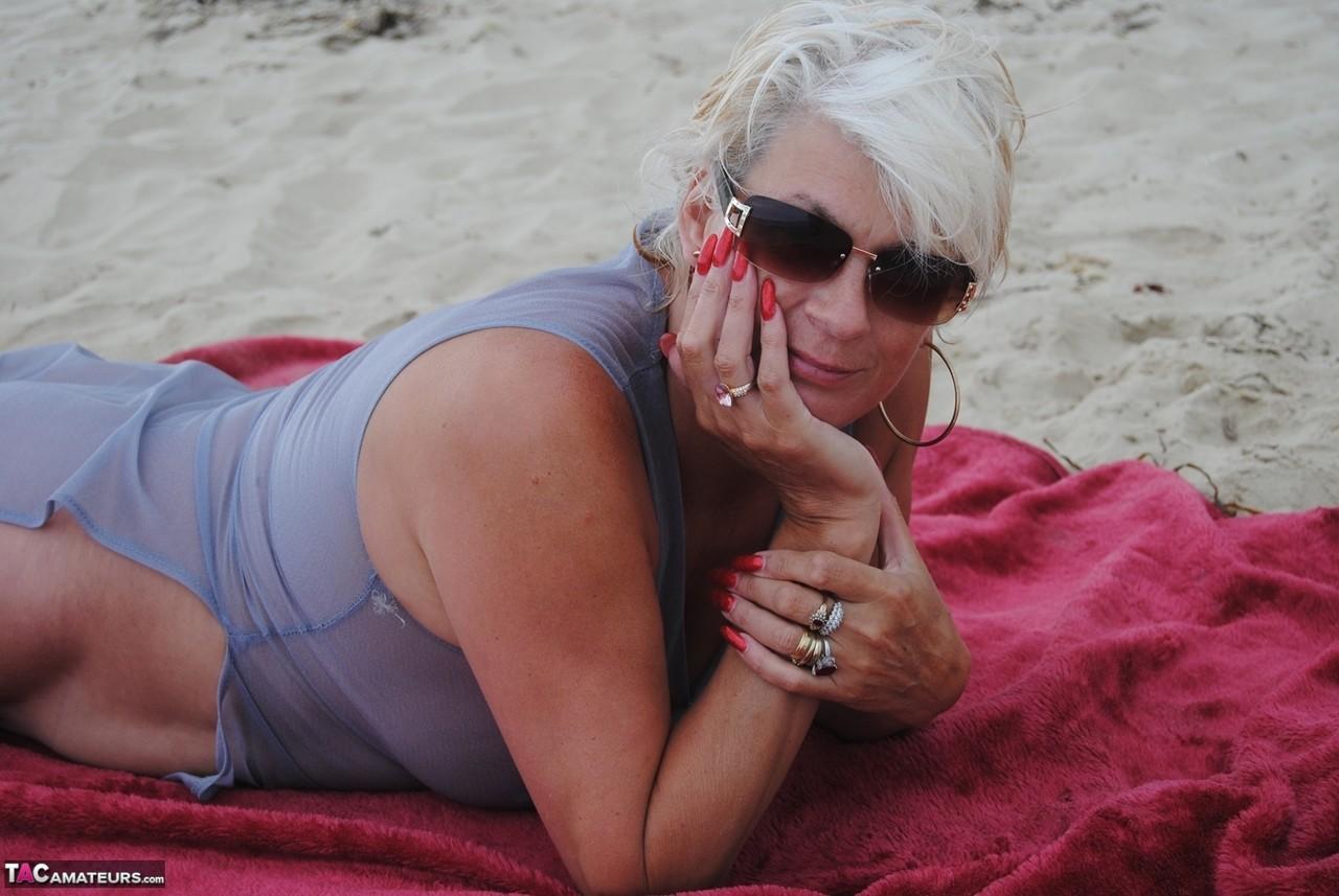 Older blonde amateur Dimonty models at the beach in see thru attire and shades(4)