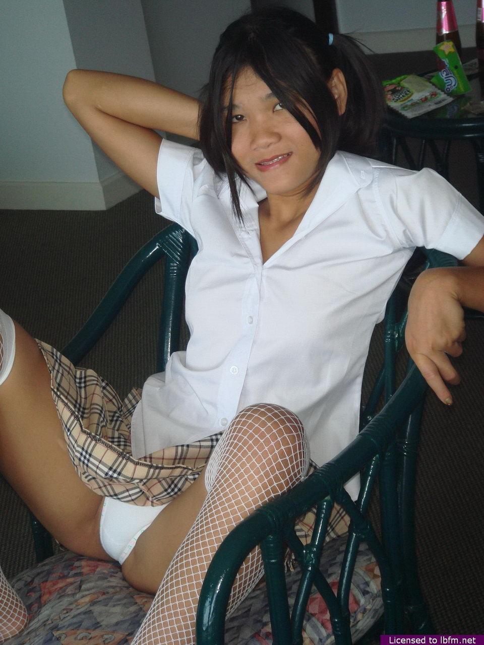 Cute Asian teen shows off her bald pussy in mesh stockings and pigtails(4)