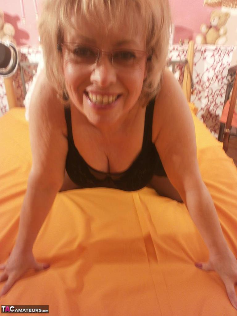 Tipsy hot granny Caro spreading legs on the bed wearing black stockings(15)