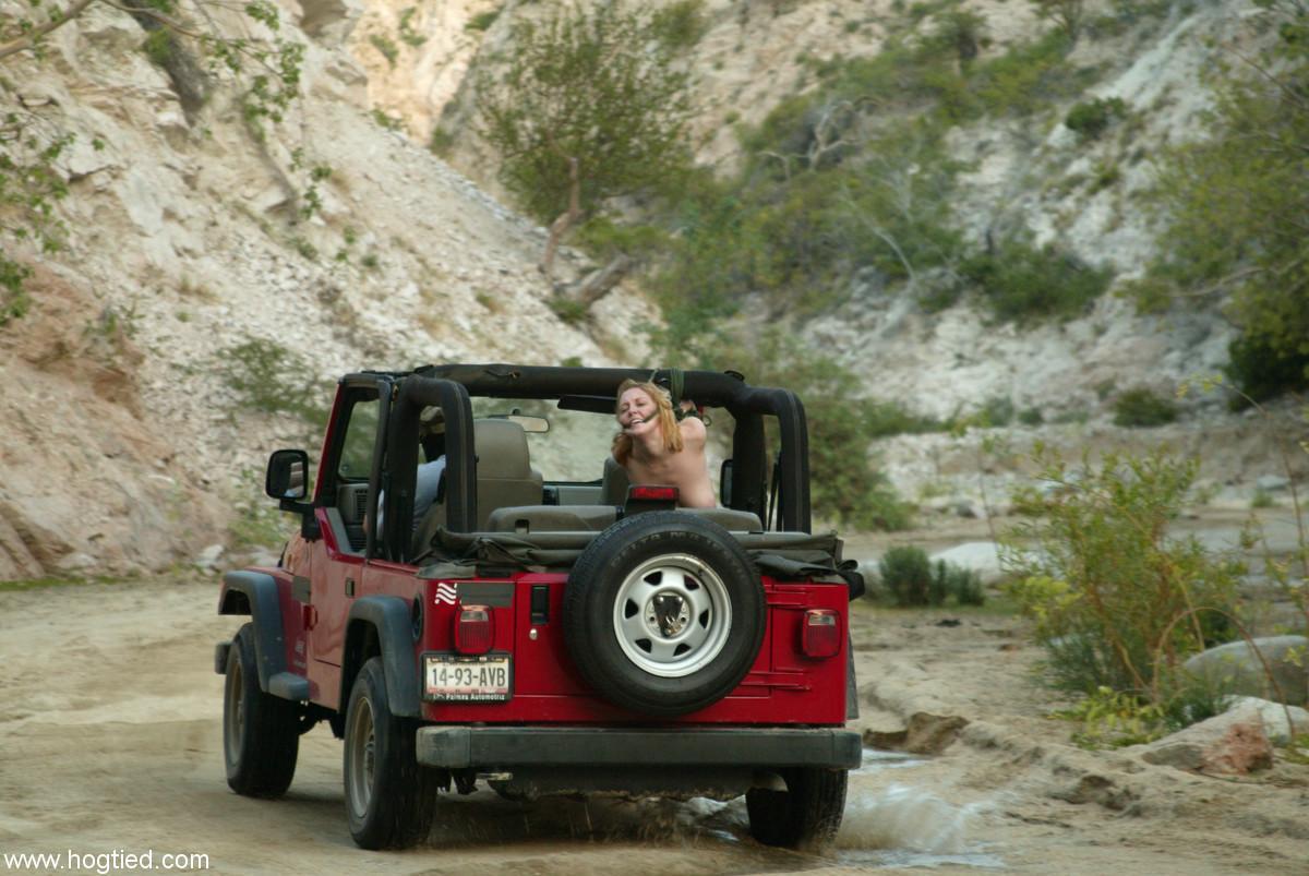 Naked MILF Dee Williams endures a rough offroad ride while standing in bondage(2)