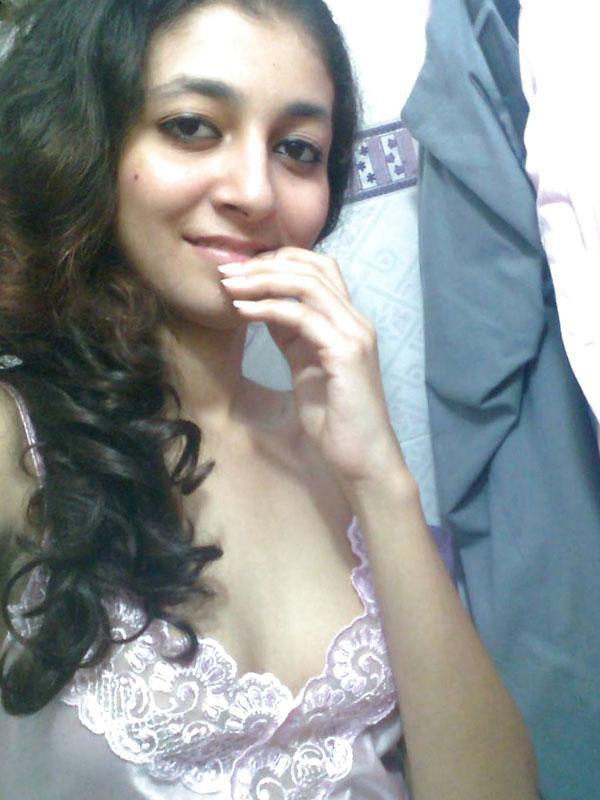 Indian solo girl holds her face firm while letting nipples free of lingerie(1)