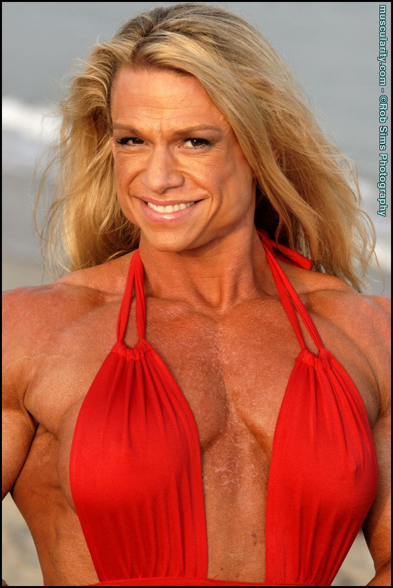 Female bodybuilder Tina Chandler models red swimwear on a beach(8)