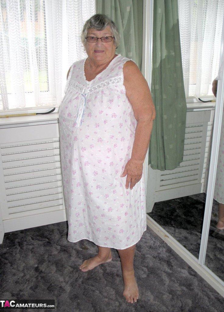 Old woman Grandma Libby grabs her fat roll after getting naked on a bed(1)