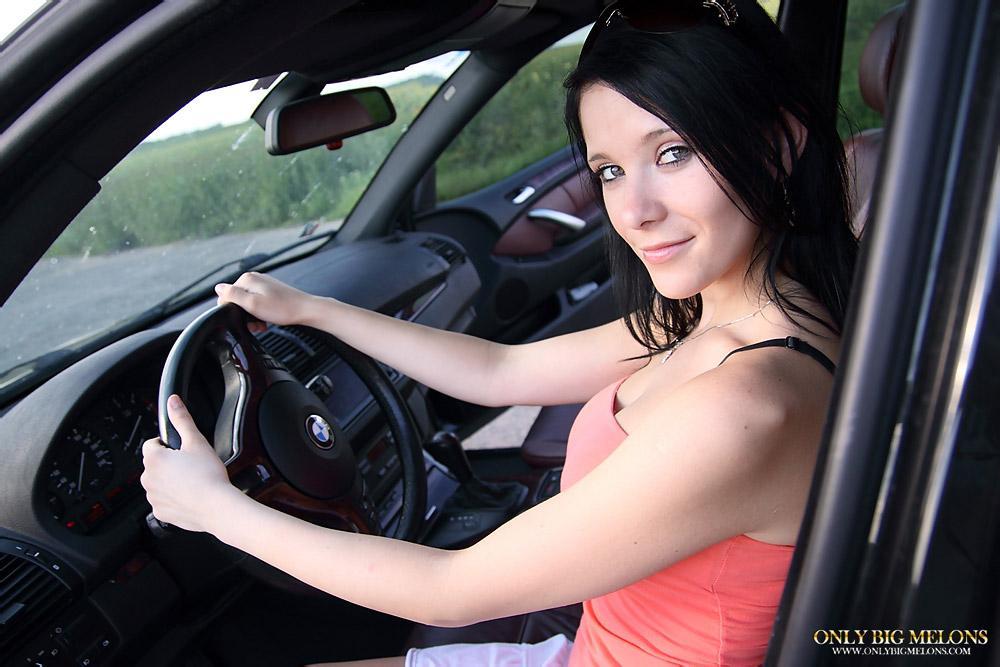 Pretty brunette uncovers her big boobs while driving a vehicle(3)