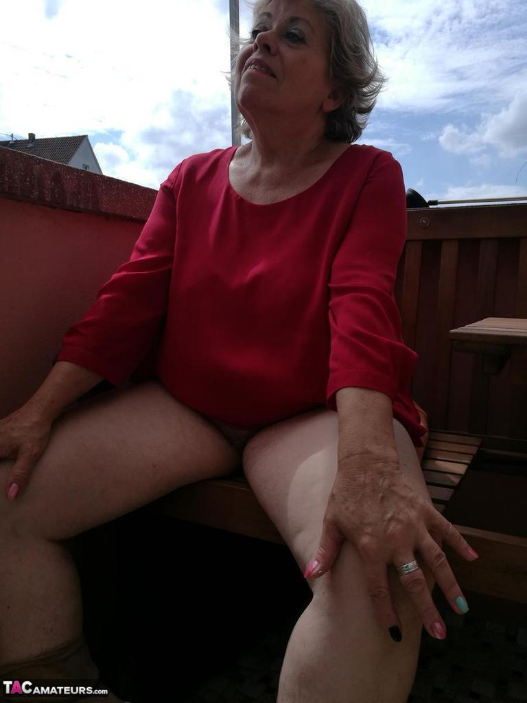 Horny oma spreads her upskirt pussy after pulling down her hose on patio(13)